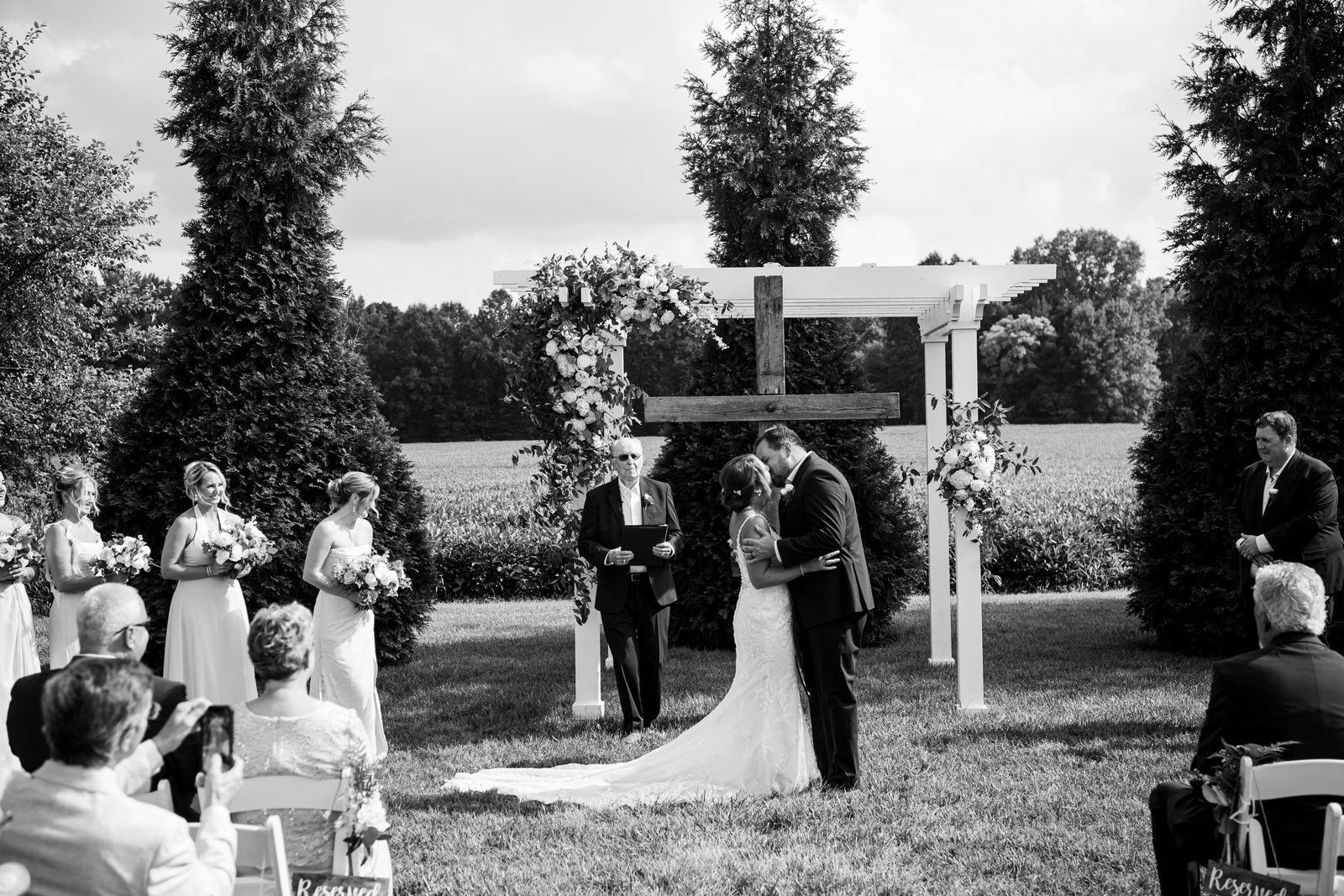 Maria and Jeremy kissing at the altar beneath a wooden cross